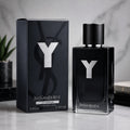 Yves Saint Laurent Le Parfum 100ml spray bottle and its black packaging box, both featuring a prominent silver 'Y' logo, set against a marble background.