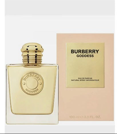 Burberry Goddess Eau de Parfum bottle with a gold cap next to its peach-colored packaging box, on a white background.