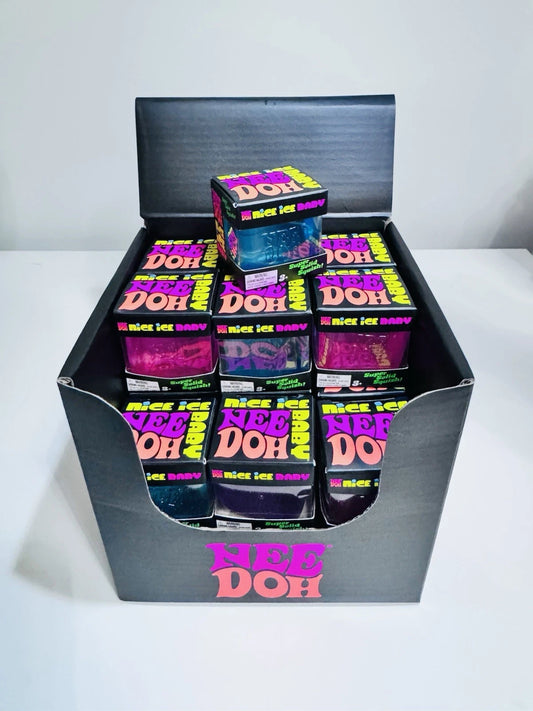 A black cardboard display box filled with multiple small square boxes of NEE DOH 'mice x lab baby' gummies. The display box and individual boxes feature bright neon pink, purple, and yellow packaging.
