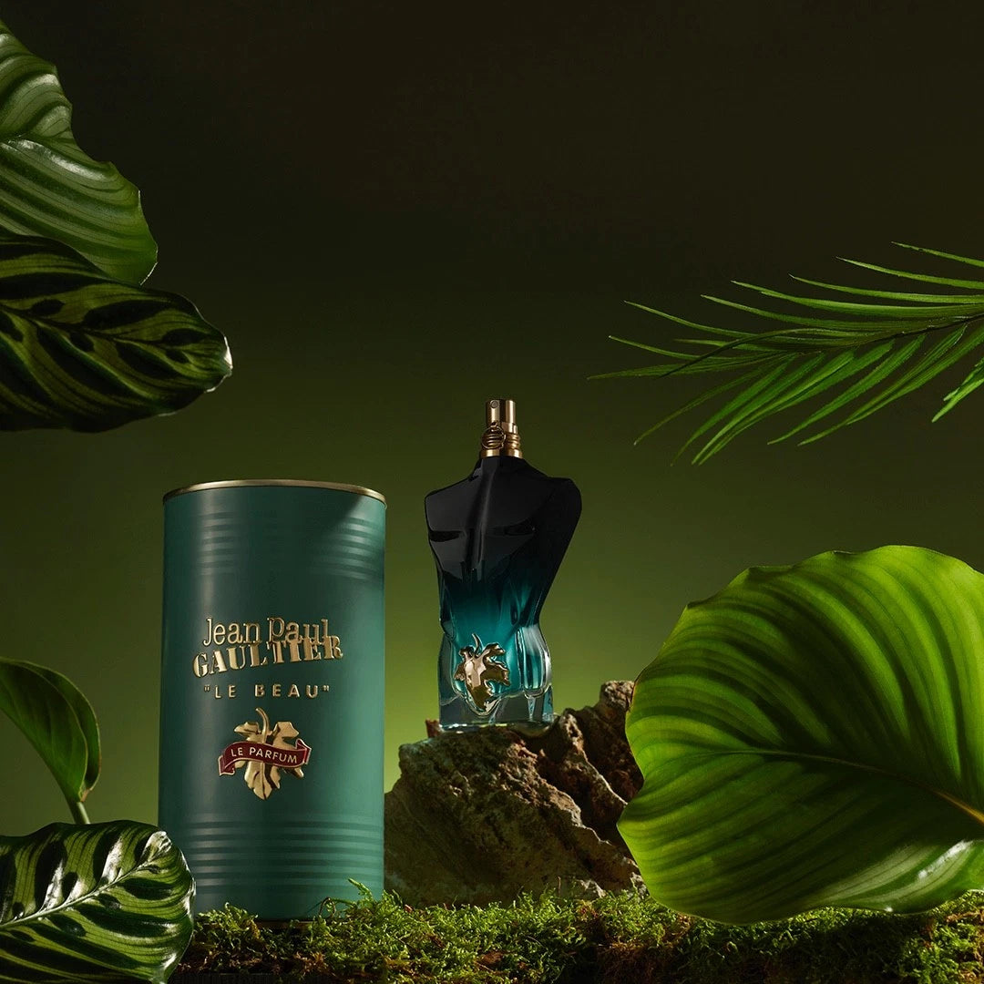 Jean Paul Gaultier perfume bottle and container with green leaves in the background
